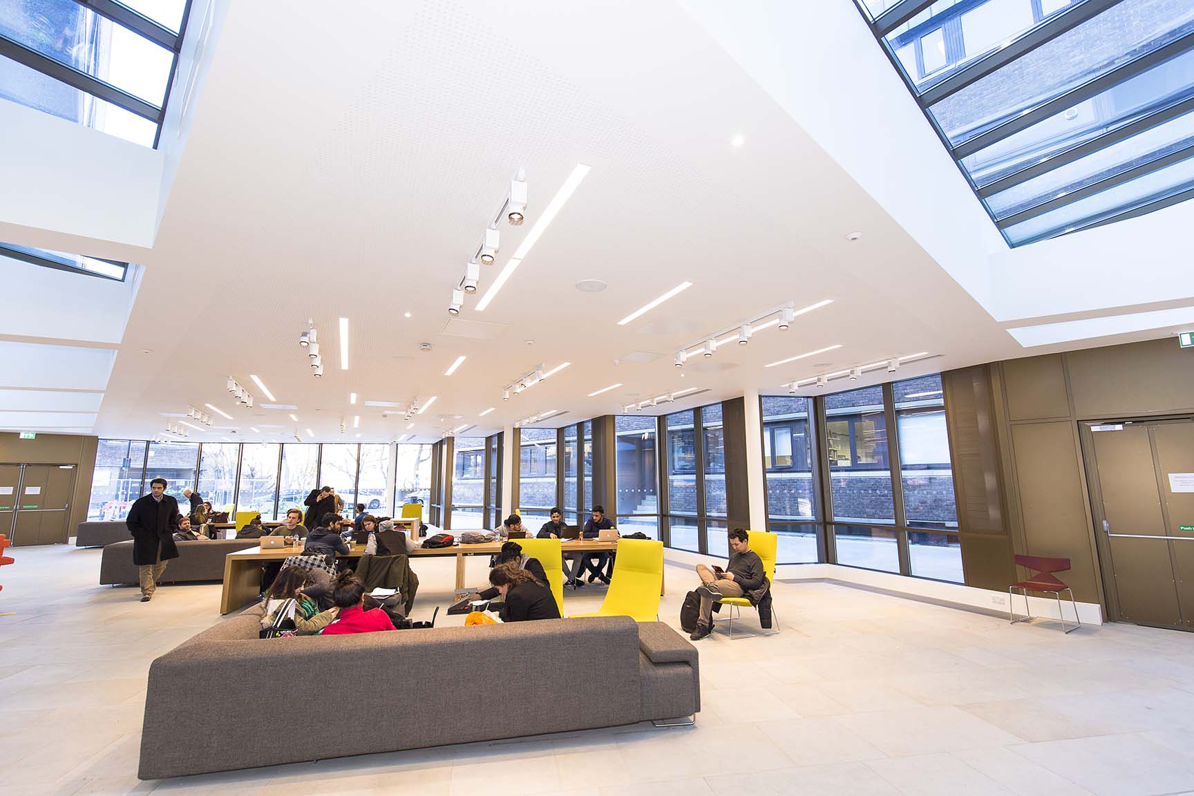 Inside view of a study lounge at a university with students on couches