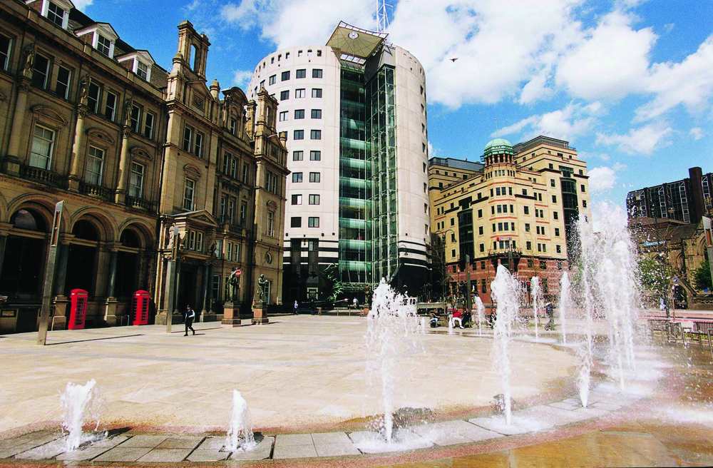 Town square with fountains, surrounded by both old and modern buldings