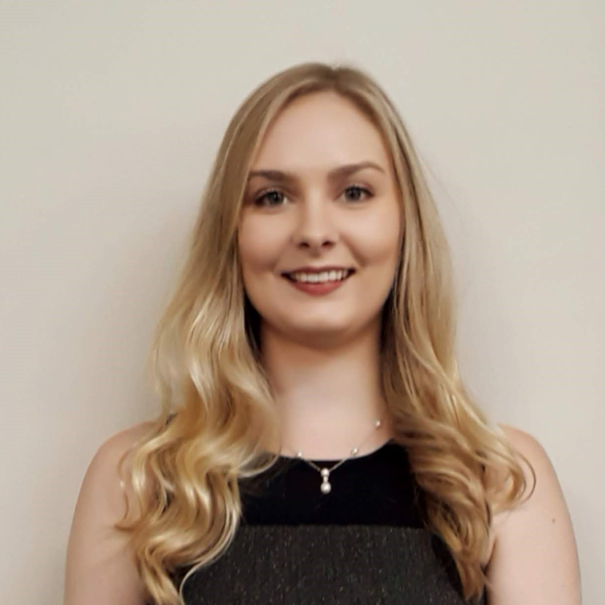 Headshot of Kathleen; blonde hair and black shirt.