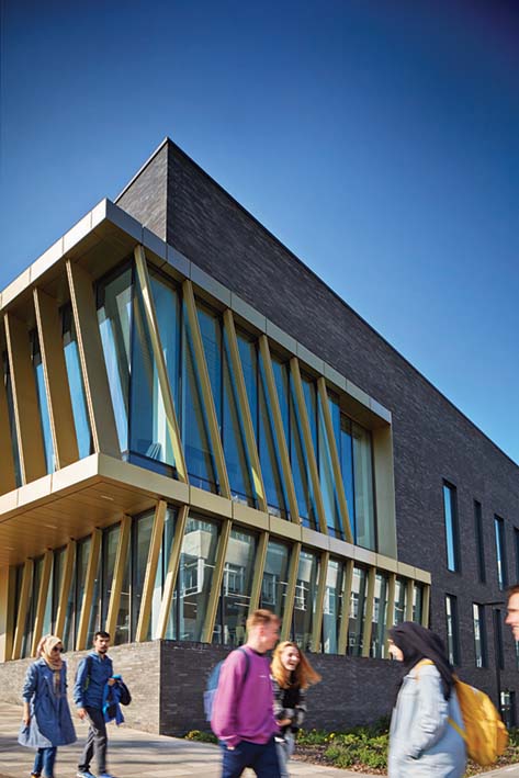 People in motion walking in front of modern building