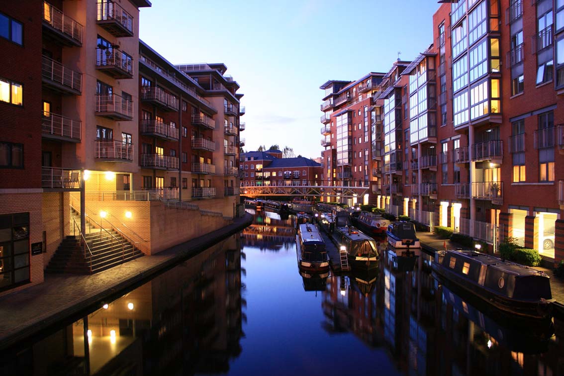 View of canal in Birmingham at dusk with lights on