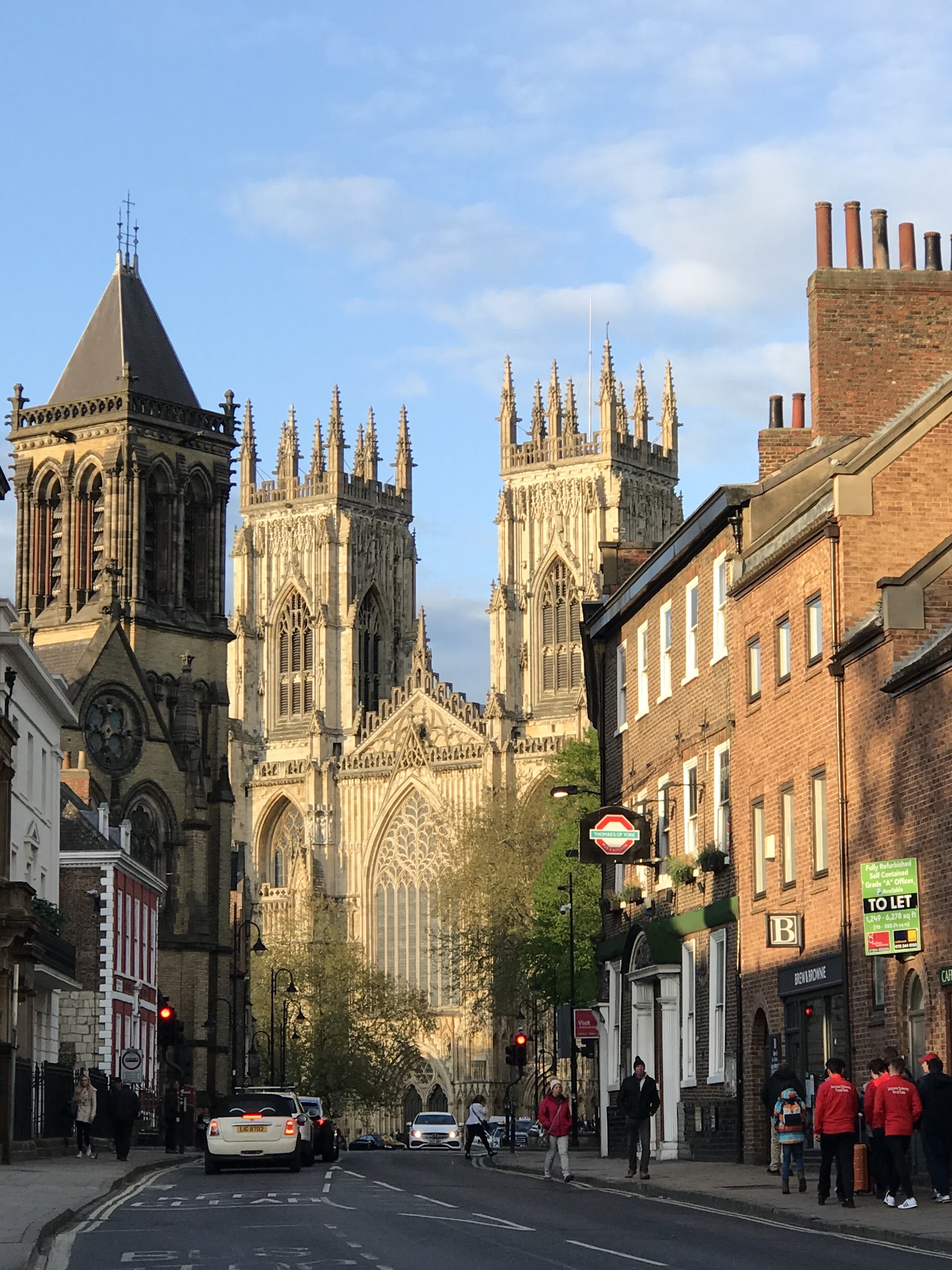 Looking down a street to York Minster Cathedral in the sun