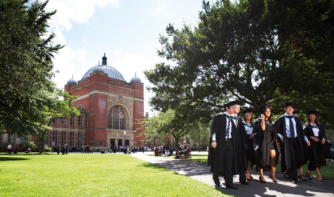 Old university building with graduating students in foreground