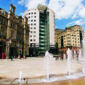 Town square with fountains, surrounded by both old and modern buldings