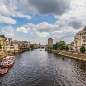 Looking down the river in York with buildings on either side of the banks