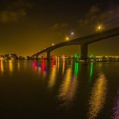 View of Southampton at night, showing the water and a bridge