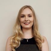 Headshot of Kathleen; blonde hair and black shirt.