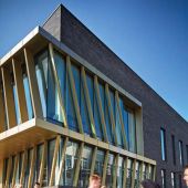 People in motion walking in front of modern building