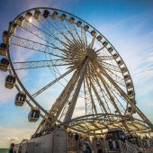 Looking up at the Brighton ferris wheel against a blue sky 