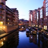 View of canal in Birmingham at dusk with lights on