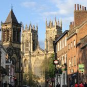 Looking down a street to York Minster Cathedral in the sun