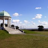 Pavillion in a green grassy park with blue sky