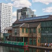 View of old canal building beside modern building